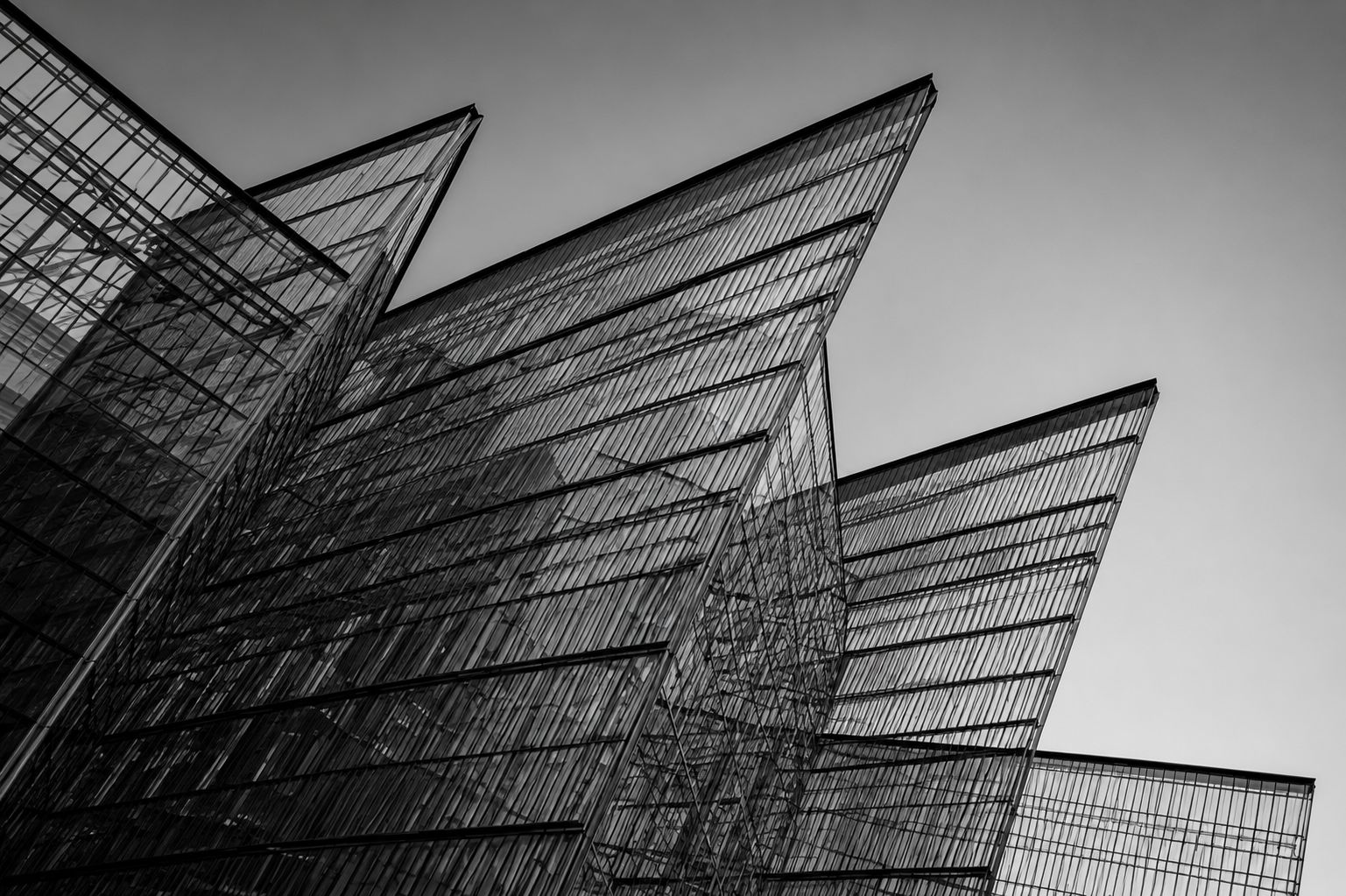 Detailed architectural drawing of a complex structure overlaid on a modern building facade.